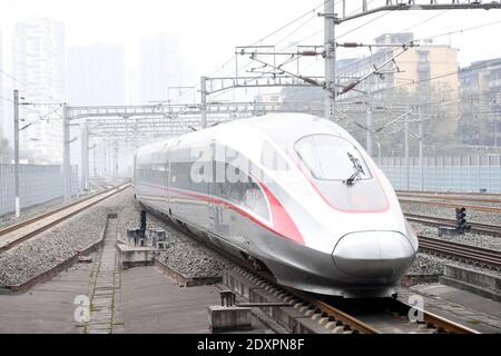 (201224) -- CHONGQING, Dec. 24, 2020 (Xinhua) -- The Fuxing high-speed train G8608 bound for Chengdu East Railway Station in southwest China's Sichuan Province, pulls out the Shapingba Railway Station in southwest China's Chongqing on Dec. 24, 2020.  On Thursday morning, with G8608 and G8607 trains respectively pulling out of Chongqing Shapingba Railway Station and Chengdu East Railway Station, the Fuxing CR400AF trains plying on the railway linking Chengdu, capital of Sichuan Province, and Chongqing Municipality were officially put into operation at a speed of 350 km/h, reducing the travel ti Stock Photo