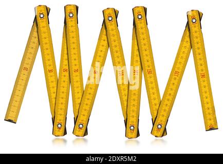 Yellow old wooden folding ruler, meter, isolated on white background with reflections.