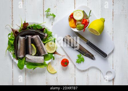 Typical Neapolitan raw fish dish of the Christmas period. Capitone, eel, cod and clams Stock Photo