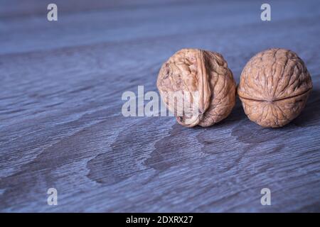 Walnuts in a row on a wooden background. Copy space Stock Photo