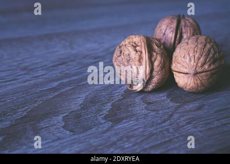 Walnuts in a row on a wooden background. Copy space Stock Photo