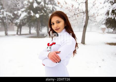 pretty girl in winter forest, young woman in winter park Stock Photo