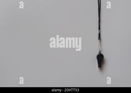 Whistle of a sport referee on grey background, free copy space