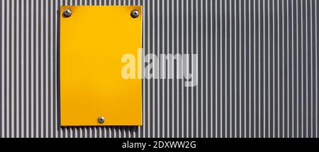 yellow plate on an industrial  fence as a background Stock Photo