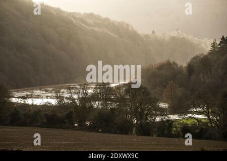 The River Wye bursts its bank in overnight flooding along the Wye Valley, Wales. River levels may yet get higher. Stock Photo