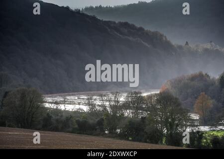 The River Wye bursts its bank in overnight flooding along the Wye Valley, Wales. River levels may yet get higher. Stock Photo