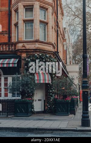 London, UK - December 5, 2020: Christmas decor on exterior of Harry's Bar, a luxurious private members club attracting rich and famous clientele in Ma