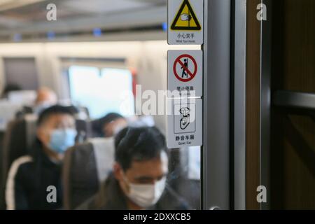 Shanghai, China. 24th Dec, 2020. Signs indicating the 'quiet car' service are seen on the 'quiet car' of the G2 bullet train of the Beijing-Shanghai high-speed railway, which links Beijing, capital of China, and east China's Shanghai on Dec. 24, 2020. Some high-speed trains in China have piloted 'quiet cars' for passengers who opt for a quiet and undisturbed travel experience. The 'quiet car' is often the No. 3 carriage on the train, with onboard videos muted and announcements made at a lower volume. Credit: Xinhua/Alamy Live News Stock Photo