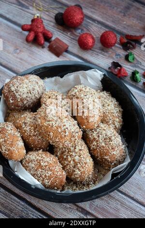 Traditional delicious Greek honey Christmas cookies melomakarona melomakarouno  with almonds and powered with honey and nuts Stock Photo