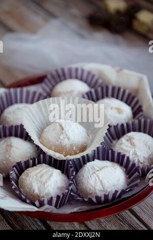 Traditional delicious Greek almond snow balls or Christmas cookies called kourabiedes with almonds and powered with white sugar Stock Photo