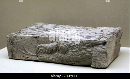 Fragment of baked clay brick, moulded and unglazed, with a mushussu-dragon's head in relief. Reign of Nebuchadnezzar II (630-562 BC). Neo-Babylonian Empire or Chaldean Empire. Louvre Museum. Paris, France. Stock Photo