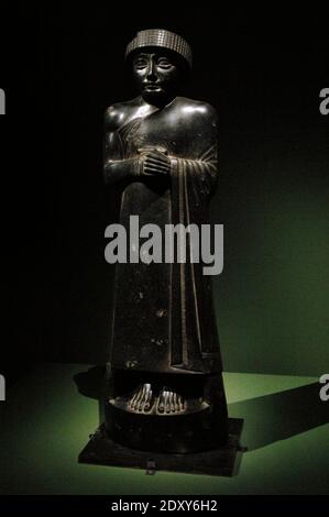 Statue of Gudea, Prince of Lagash State. Girsu (present day Tello, Iraq). Mesopotamia. Diorite, c. 2120 BC. Second dynasty of Lagash. Louvre Museum. Paris, France. Stock Photo