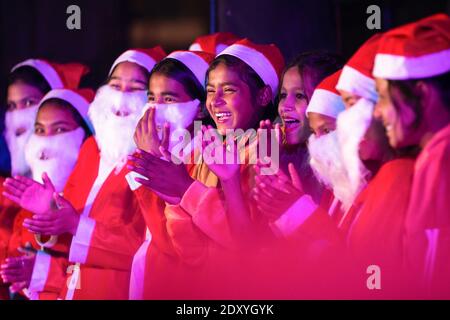 Nepalese boys and Girls dressed as Santa Claus take part in a Christmas