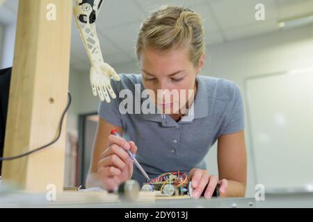 young female technician while machine constructing Stock Photo