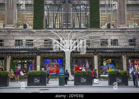 In spite of the Covid-19 pandemic Saks Fifth Avenue keeps up the holiday spirit with its decorated windows on 'Black Friday.' Although the numbers are way down some people are out shopping. Stock Photo