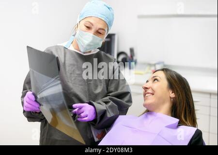 Doctor dentist showing patient's teeth on X-ray. High quality photo Stock Photo