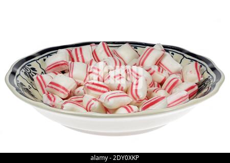 Dutch peppermint confectionery in Delftware bowl isolated on wooden background Stock Photo