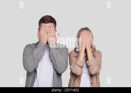 Couple Cover Eyes by Hands Standing Isolated Stock Photo