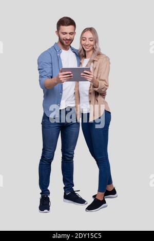 Couple Watching in Tablet Standing Isolated. Commecial, Shpping, Advertisment Concept Stock Photo