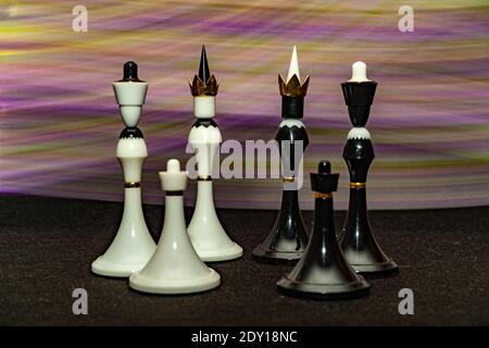 Chess pieces in black and white on a rainbow colored background. The concept of a peaceful outcome. The reconciliation of enemies Stock Photo