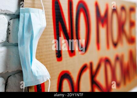 Protestive placard against coronavirus lockdowns against wall Stock Photo