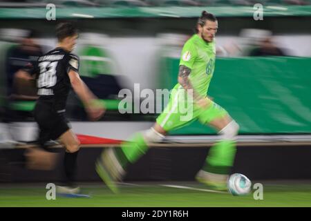 Wolfsburg, Germany. 23rd Dec, 2020. Football: DFB Cup, VfL Wolfsburg - SV Sandhausen, 2nd round at Volkswagen Arena. Wolfsburg's Daniel Ginczek controls the ball. (Shot with slow shutter speed) Credit: Swen Pförtner/dpa - IMPORTANT NOTE: In accordance with the regulations of the DFL Deutsche Fußball Liga and/or the DFB Deutscher Fußball-Bund, it is prohibited to use or have used photographs taken in the stadium and/or of the match in the form of sequence pictures and/or video-like photo series./dpa/Alamy Live News Stock Photo