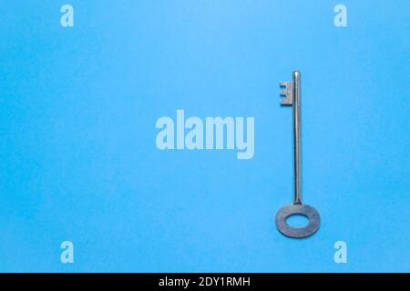 Key on blue colored background placed at the right side. Stock Photo