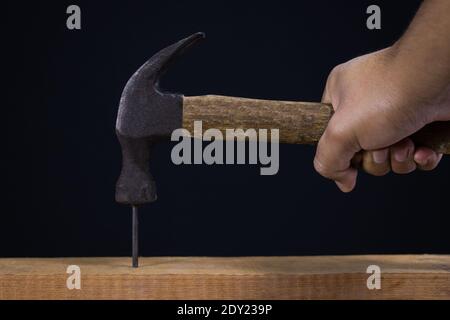 Hammer with nail on black background Stock Photo