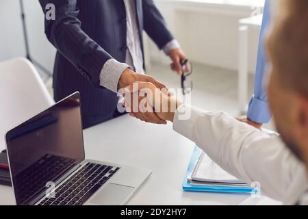 Business partners shaking hands, confirming collaboration and financial agreement Stock Photo