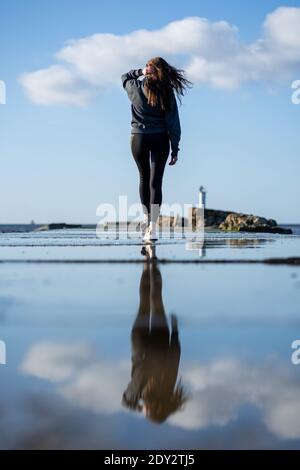 Pretty woman from back and her water reflection Stock Photo
