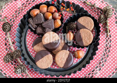 chocolate cookies with hazelnuts on baking pan Stock Photo