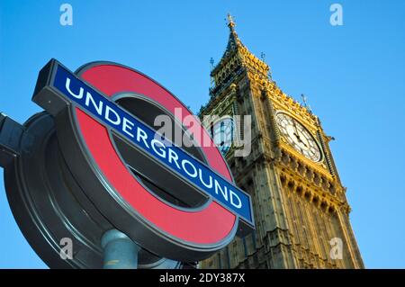 A London 'underground' station sign and 'Big Ben,' the famous neo-gothic clock and tower at the Palace of Westminster, London, England. Stock Photo