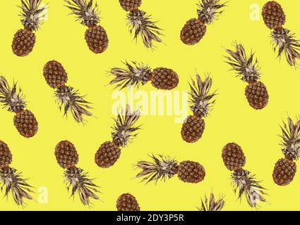 tropical pattern with exotic pineapple fruit on a yellow background Stock Photo