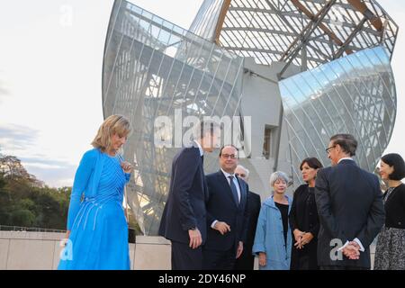 LVMH luxury group CEO Bernard Arnault, second left, his wife Helene Mercier  Arnault, left, French President Francois Hollande, center right, and  American architect Frank Gehry attend the inauguration of the Louis Vuitton