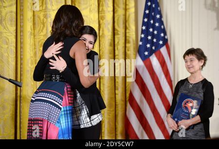 First Lady Michelle Obama presents the 2014 National Arts and Humanities Youth Program Award to Jennifer Gonzales from Chicago, IL as Director of Education Marilyn Halperin looks on during a ceremony in the East room of the White House in Washington, DC, USA, November 10, 2014 Photo by Olivier Douliery/ABACAPRESS.COM Stock Photo