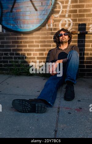 Relaxed portrait of Millennial man in urban environment Stock Photo