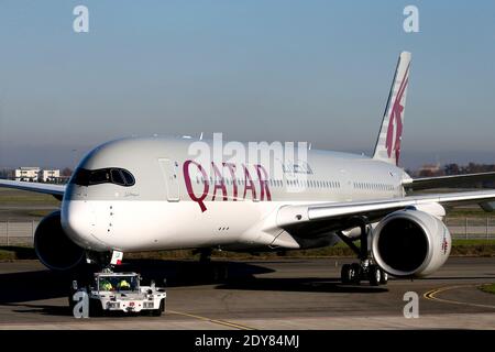 One of the two Airbus A350-900 aircrafts for the Qatar Airways company at the Airbus Group center in Toulouse, southern France on December 22, 2014. The A350, whose wings and fuselage are made of carbon fibre, is designed to save up to 25 percent in fuel consumption while serving long-range routes. Qatar Airways has ordered 80 of the aircraft and plans to make them the workhorse of its fleet. Photo by Patrick Bernard/ABACAPRESS.COM Stock Photo