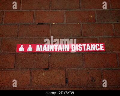 Maintain social Distancing sign on walkway during covid pandemic in California