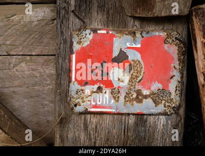 Old rusted vintage sign with a number five still visible on vintage wood Stock Photo