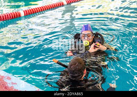 pair of divers in the water planning an activity Stock Photo