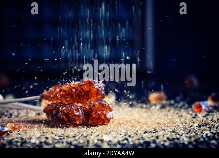 Candy cane sugar, brown sugar sticks on a dark table, selective focus Stock Photo