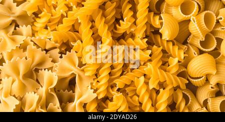 Grocery background of various types of pasta. Stock Photo