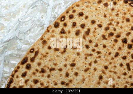 Matzo texture, a top view of a piece of traditional wheat dry bread served on Hebrew Passover. baked matzo, matzo texture, background. Stock Photo