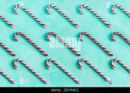 Christmas striped candy cane isolated on blue background. Candy cane pattern. Top view Stock Photo