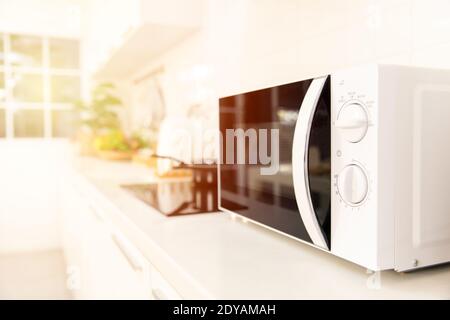 Kitchen counter closeup microwave oven cooking machine Stock Photo
