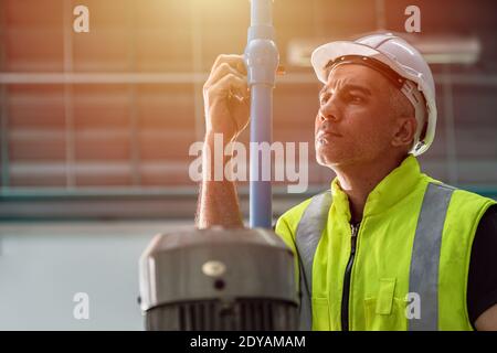 Professional engineer service team working maintenance and repair water pipe in factory Stock Photo