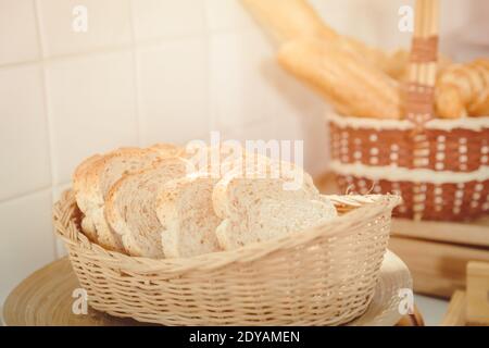 Whole wheat or whole grain sliced bread in wooden basket Stock Photo