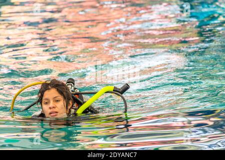 female diver swimming on the surface without her breathing mask Stock Photo