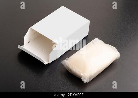 Opened soap package box on black surface, editable mock-up series template ready for your design, faces selection path included. Stock Photo