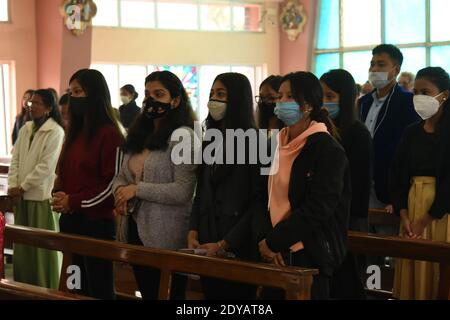 Guwahati, Assam, India. 24th Dec, 2020. Christian community by wearing safety mask due to coronavirus pamndemics offer prayer inside the church during the celebration Christmas at Don Bosco Church Panbazar in Guwahati Assam India on Friday 25th December 2020. Credit: Dasarath Deka/ZUMA Wire/Alamy Live News Stock Photo